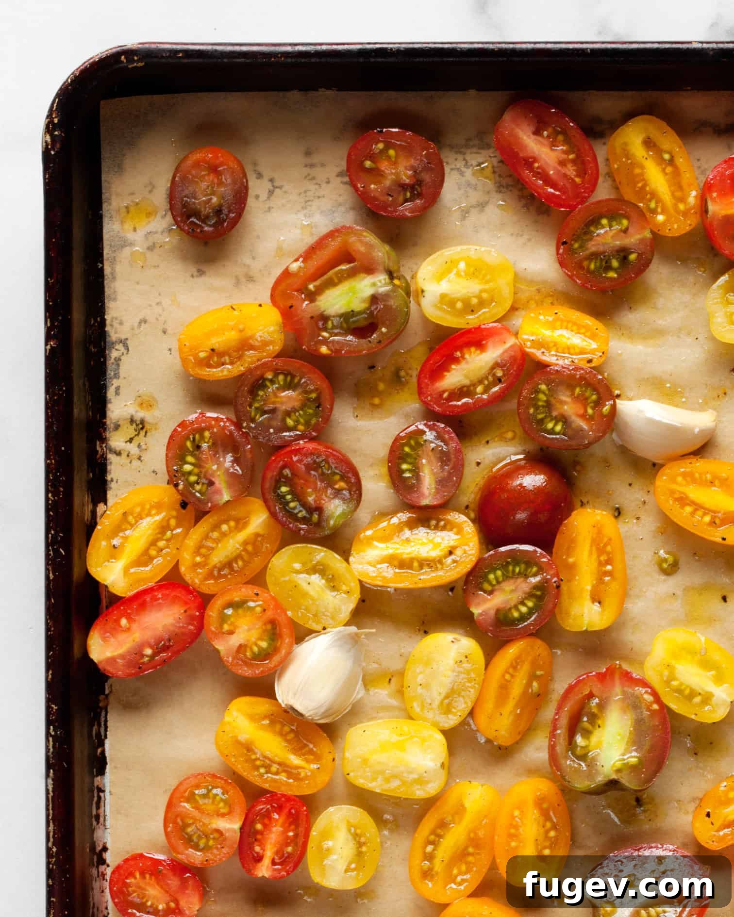 Sun-Kissed Tomato Burrata 6 Halved cherry tomatoes and garlic on a sheet pan