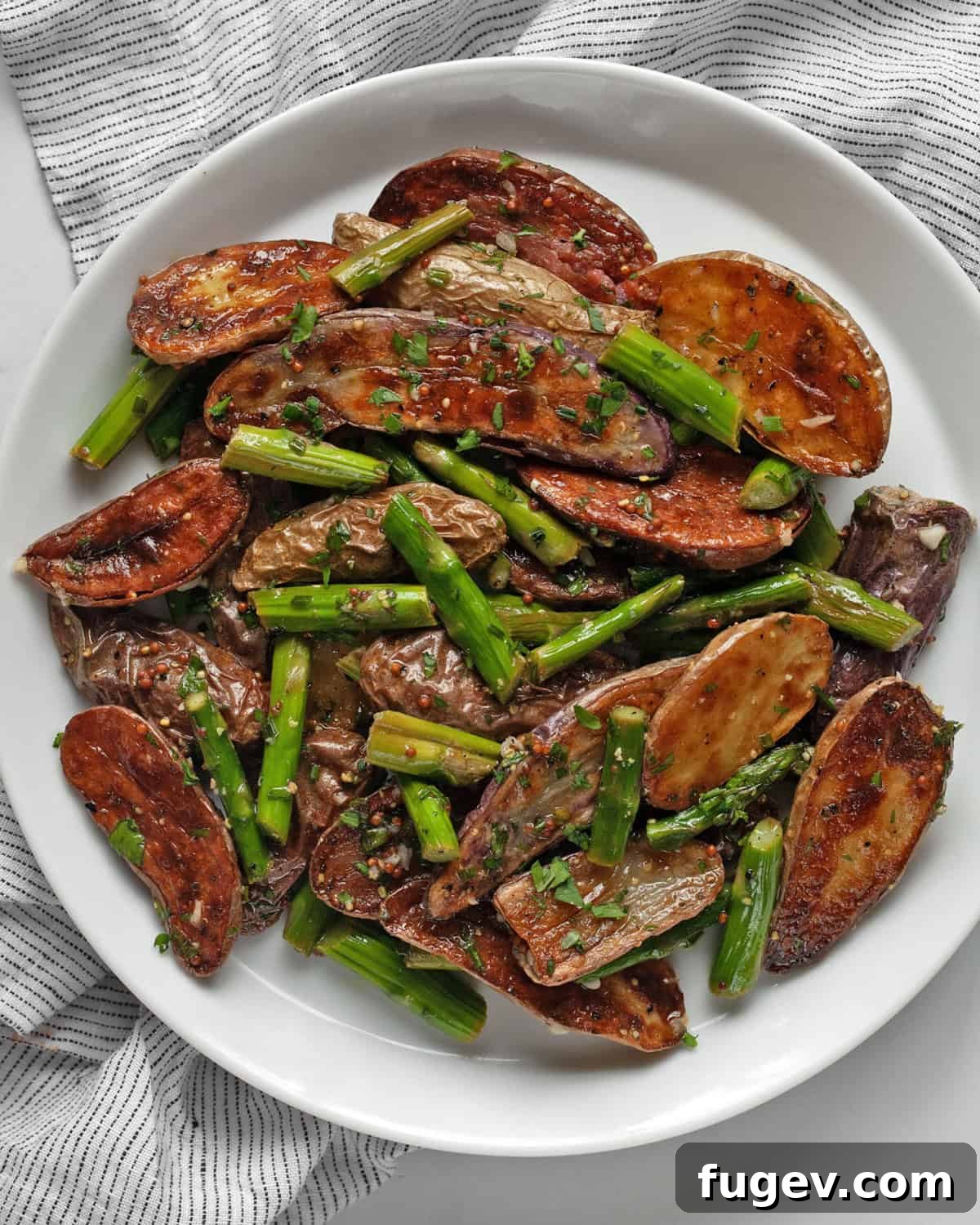 5 Must-Try Potato Salad Recipes 2 Roasted asparagus potato salad on a plate.