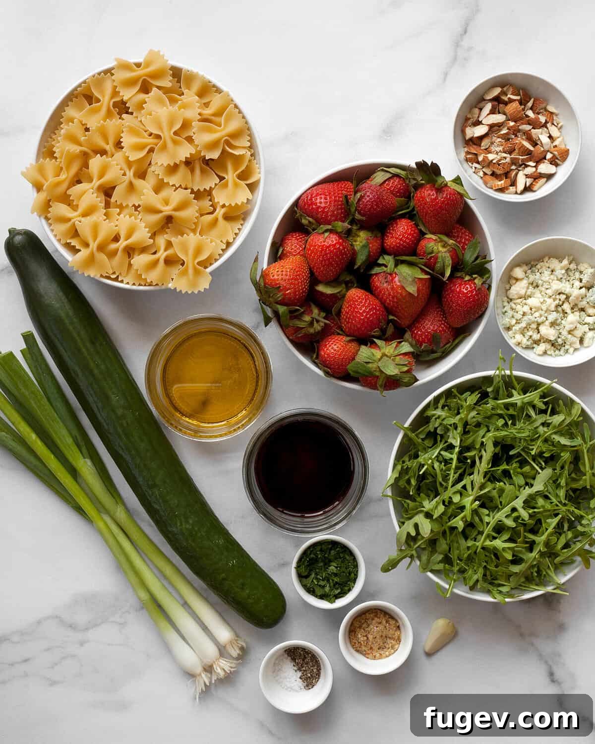 Strawberry Cucumber Pasta Medley 3 Ingredients including pasta, cucumber, strawberries, arugula, scallions, blue cheese, almonds, balsamic vinegar and olive oil.