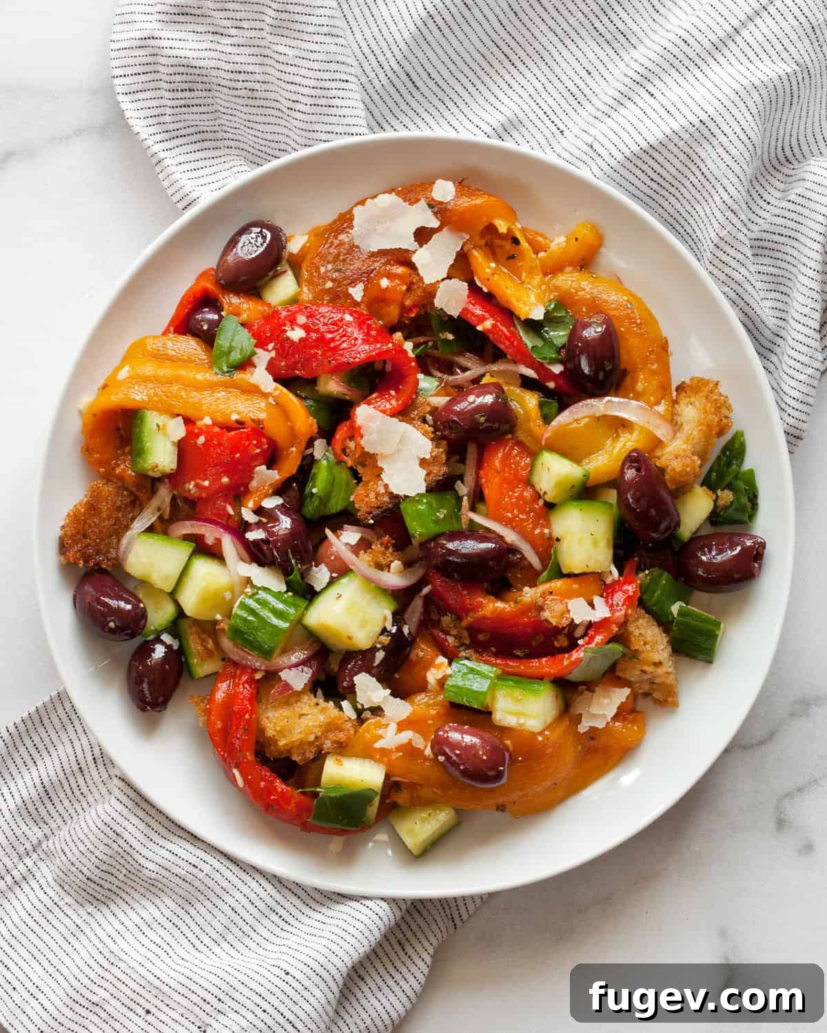 Fire-Kissed Pepper Salad 2 Roasted bell pepper salad served on a white plate, showcasing vibrant colors and fresh ingredients.