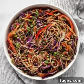 Salad with soba noodles, cabbage, carrots and bell peppers in a bowl.