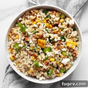 Grilled corn couscous in a bowl, showcasing the textures and colors of the ingredients.