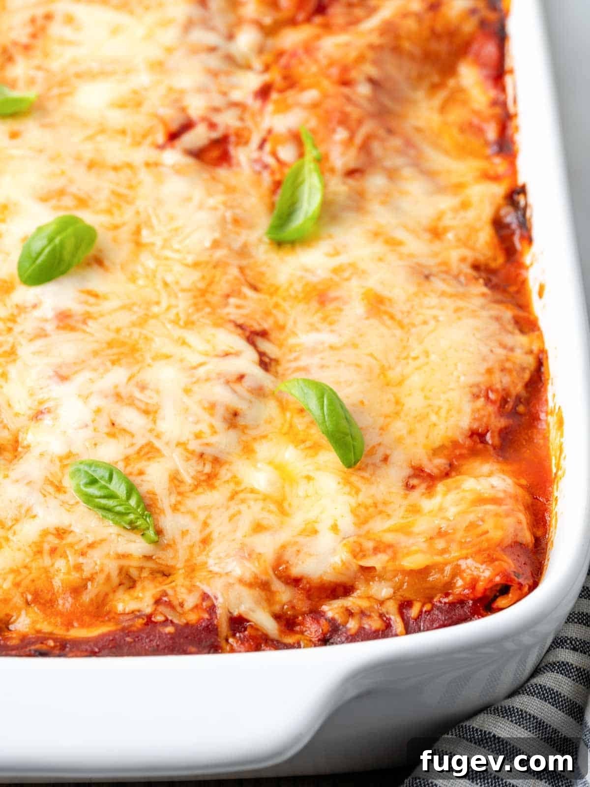 Vibrant Veggie Lasagna 13 A close-up shot of a baked vegetable lasagna, bubbling hot straight from the oven, with a perfectly golden and melted cheese topping.