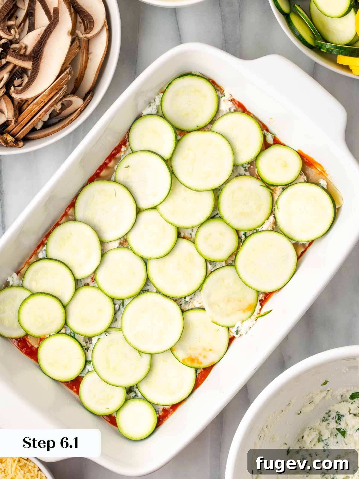 Vibrant Veggie Lasagna 8 Layering thinly sliced zucchini over a ricotta layer in a lasagna dish.