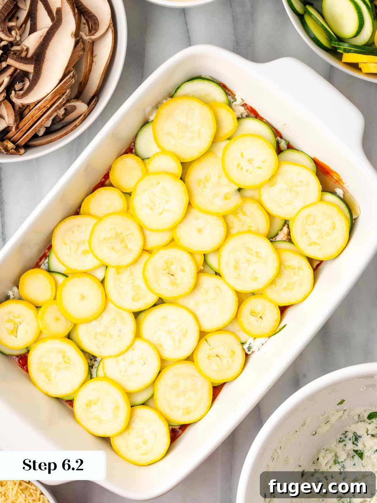 Vibrant Veggie Lasagna 9 Adding a layer of thinly sliced yellow summer squash on top of the zucchini in the lasagna dish.