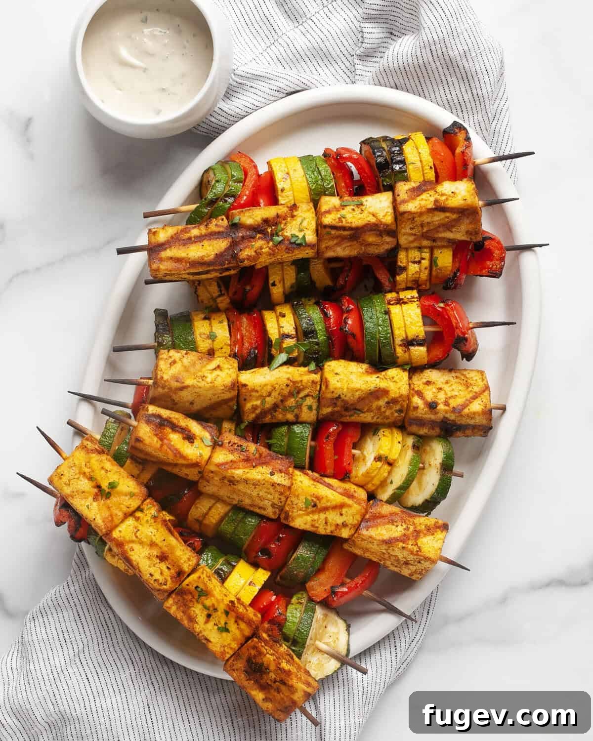 Spiced Grilled Tofu Shawarma 8 Grilled tofu and vegetable skewers artfully arranged on a serving platter, showcasing the golden char and vibrant colors.
