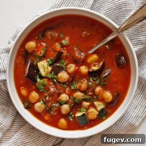 A cozy bowl of roasted eggplant zucchini tomato stew, rich with vegetables and herbs.