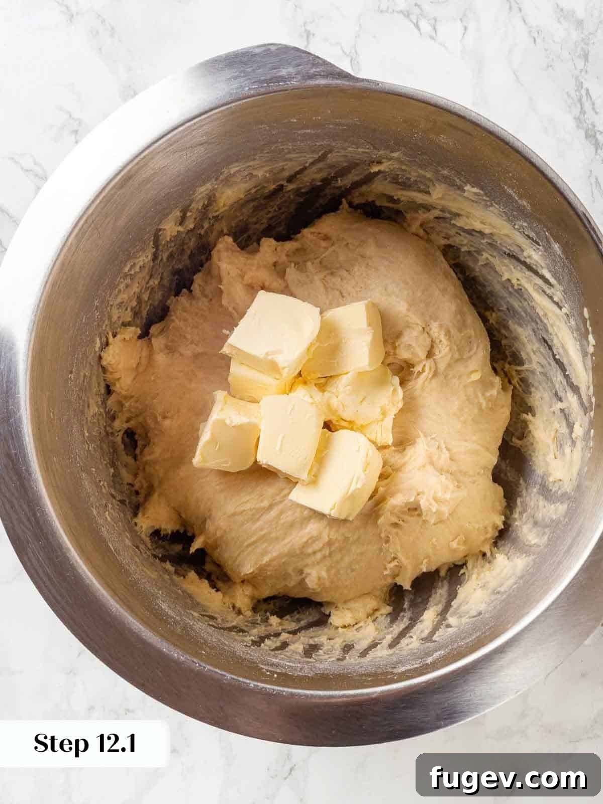 Pillowy Potato Loaf 10 Cubes of butter being added to the mixing bowl with dough in progress for potato bread.