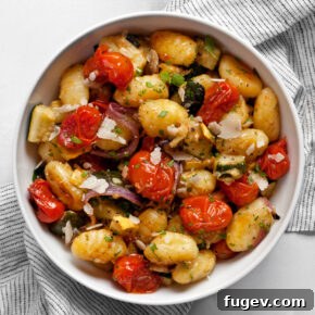 Sheet pan gnocchi with roasted vegetables in a bowl.