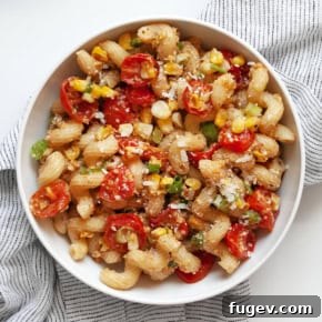 Pasta with corn pesto and roasted tomatoes in a bowl.