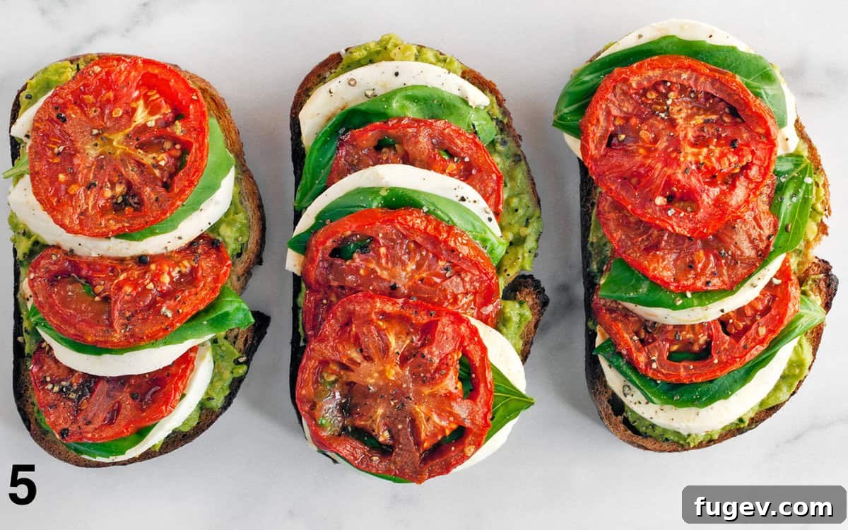 Fresh Caprese Avocado Toast 5 Three perfectly assembled slices of Caprese Avocado Toast, ready to be served.