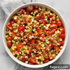 Fresh corn and tomato salad in a bowl.