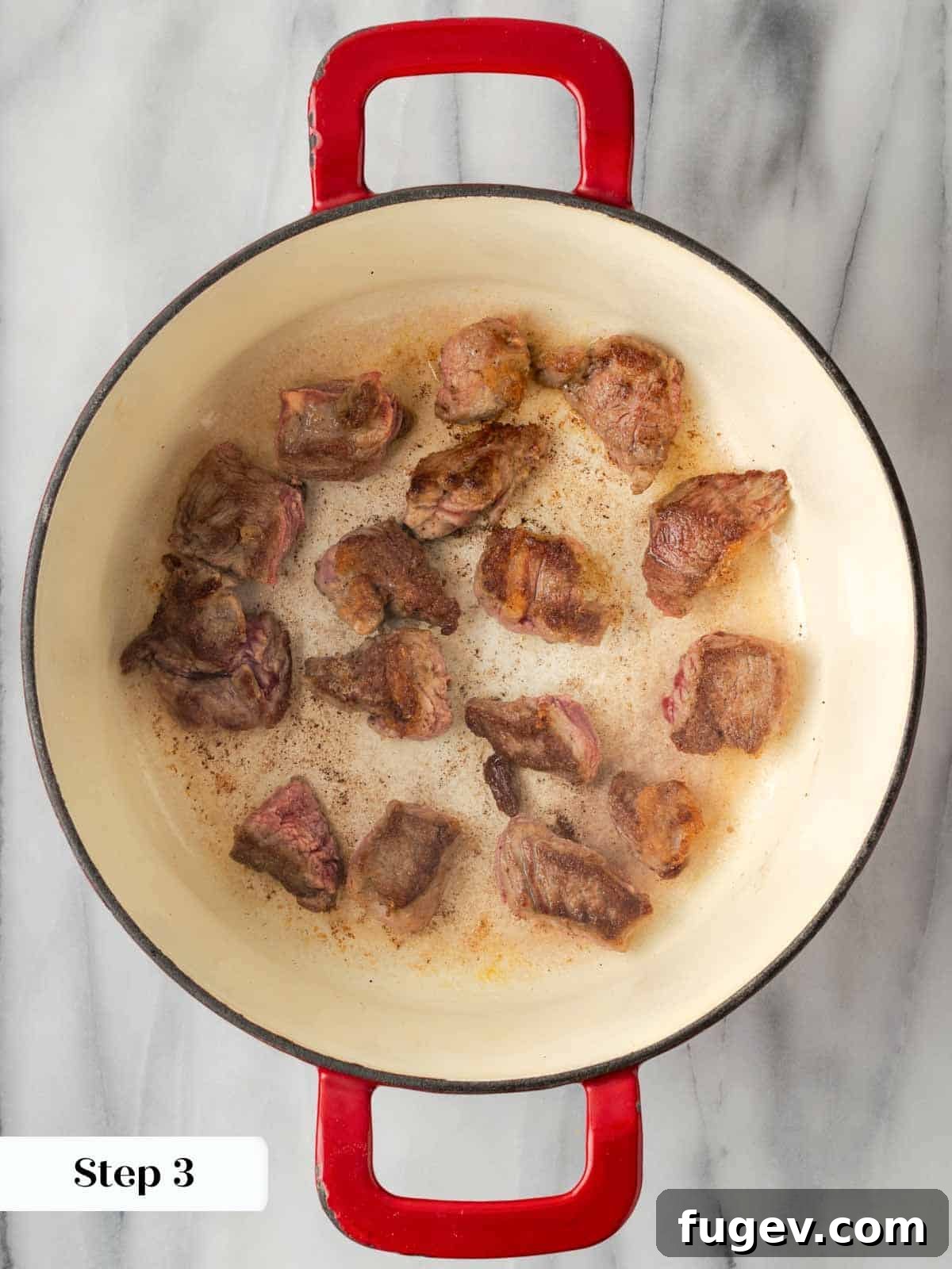 Classic Cast Iron Beef Stew 8 Beef stew meat browning in a Dutch oven, showing a rich, caramelized crust.