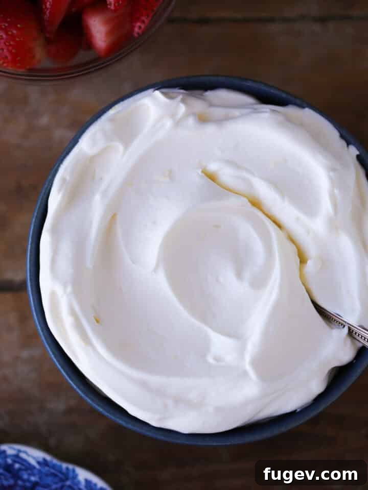 Zesty Cloud Cream 2 Lemon Whipped Cream in a blue bowl with vintage spoon, ready to be served