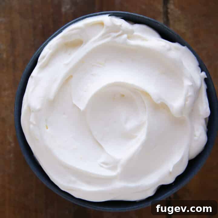 Zesty Cloud Cream 5 Lemon Whipped Cream swirled into a blue bowl, showcasing its smooth texture