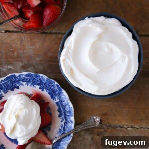 Lemon Whipped Cream in blue bowl with strawberries, a close-up for the recipe card