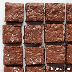 Fudge brownies arranged in neat rows, highlighting their rich color and texture.