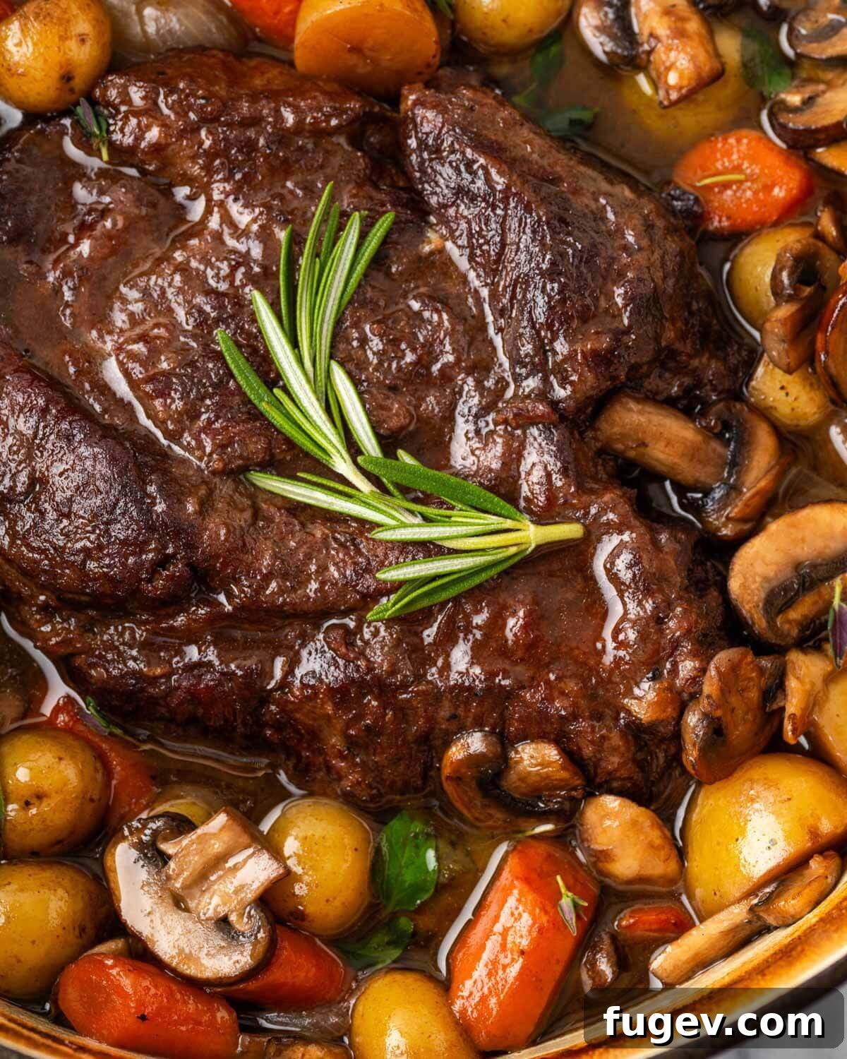 Perfectly Cooked Dutch Oven Pot Roast Delicious Dutch oven pot roast served with carrots, potatoes, and mushrooms.