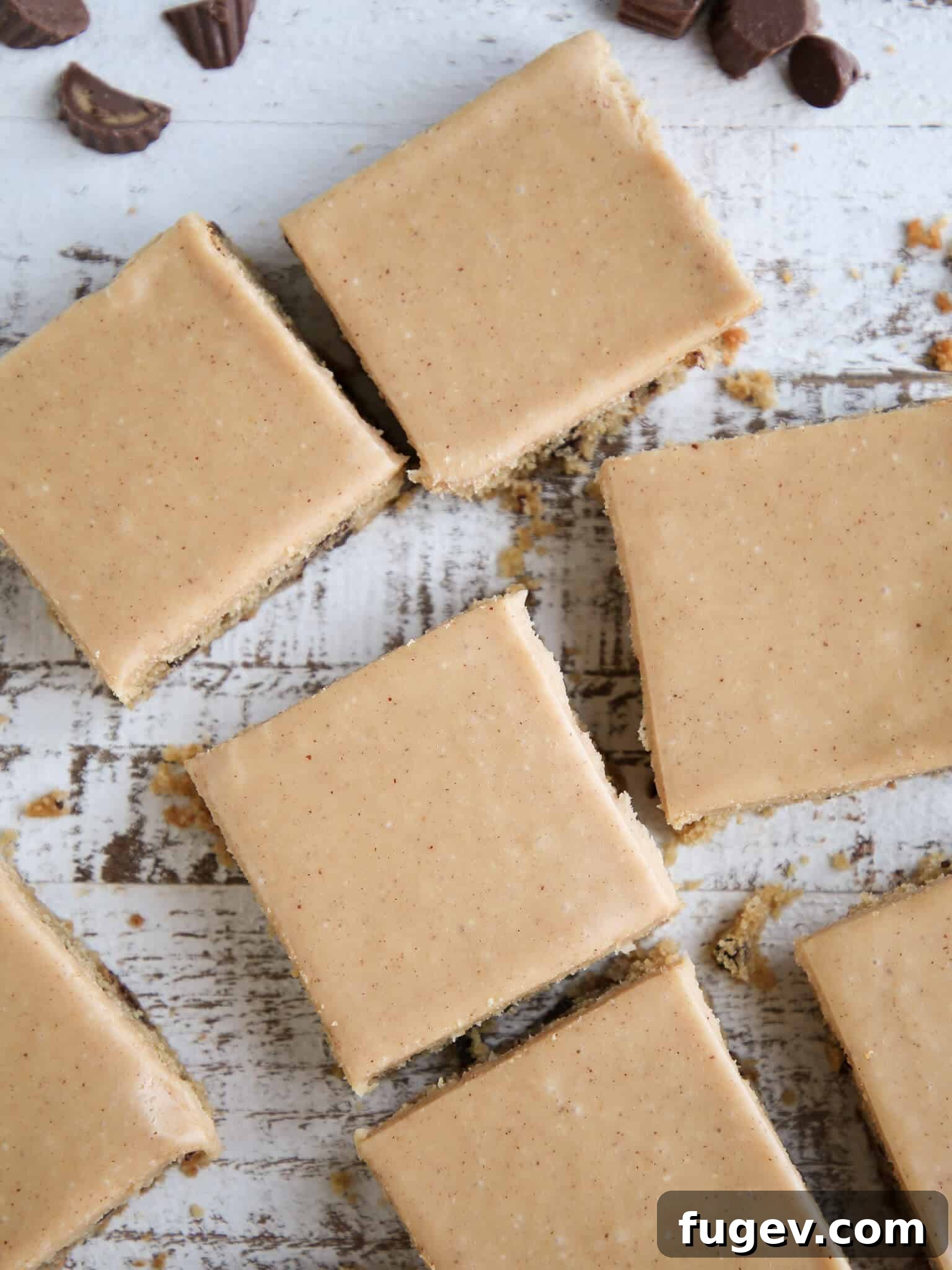 Peanut Butter Chocolate Swirl Blondies 4 Reeses Peanut Butter Blondies sliced on wooden surface, showing the beautiful layers and generous mix-ins.