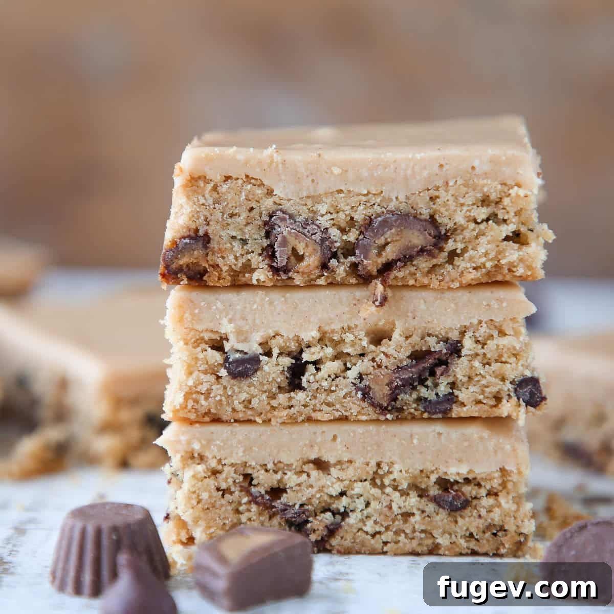 Peanut Butter Chocolate Swirl Blondies 5 Reeses Peanut Butter Blondies sliced and stacked, revealing the dense, chewy texture and plentiful peanut butter chips and cups.