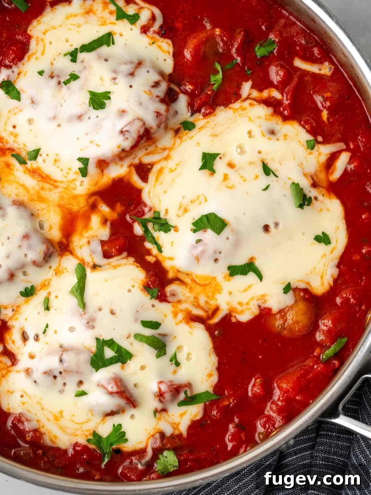 Hearty Marinara Chicken Bake 2 cheesy baked chicken marinara, steaming hot in a skillet.