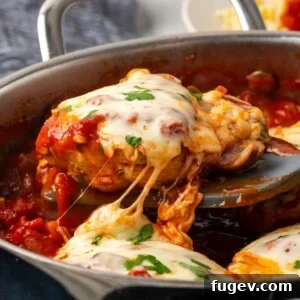 cheesy chicken being served from pot.
