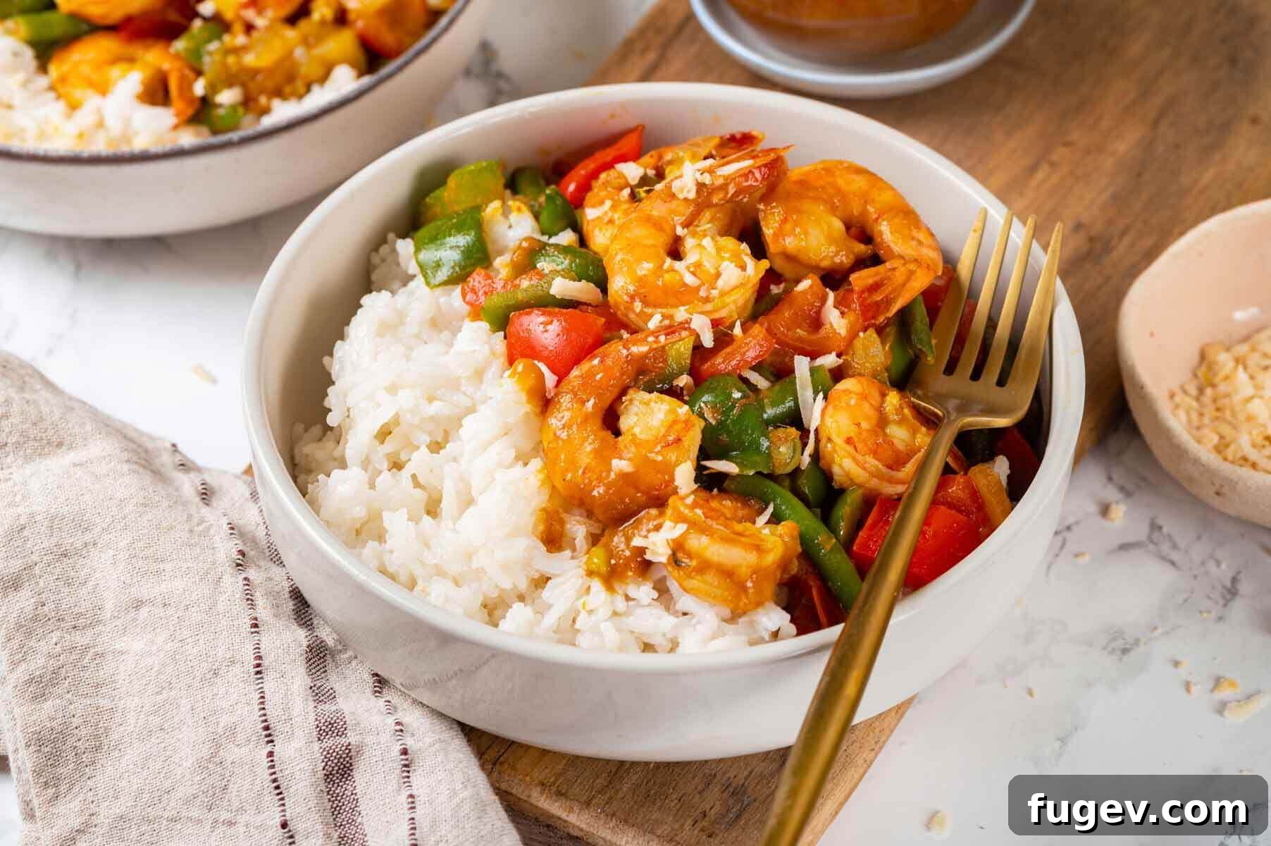 Aromatic Golden Prawns 13 Two enticing bowls of homemade shrimp curry with coconut rice, perfectly garnished and ready for a shared meal.
