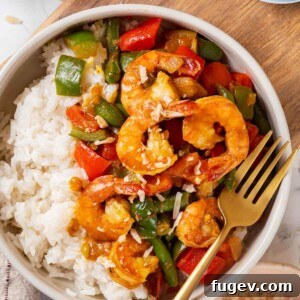 Aromatic Golden Prawns 14 A served portion of shrimp curry ready to eat.