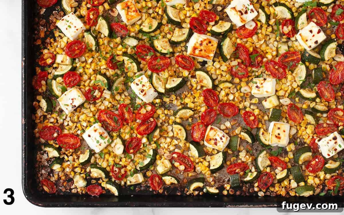 Tek Tepside Fırınlanmış Feta ve Sebzeler 5 Golden-brown baked feta and perfectly roasted summer vegetables on a baking sheet, fresh out of the oven.
