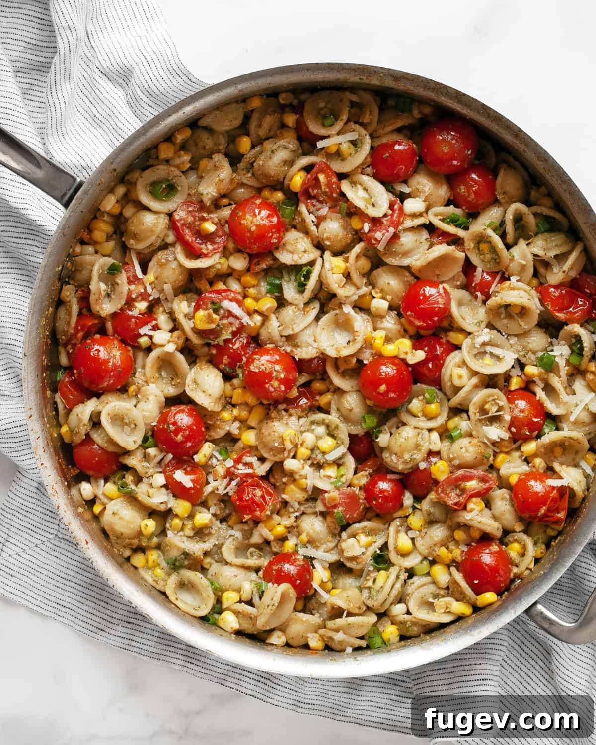 Summer Harvest Orecchiette 2 Vibrant Tomato Corn Orecchiette pasta served in a large skillet, ready to be enjoyed.