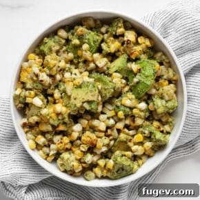 Grilled corn and avocados with cilantro pesto in a bowl.