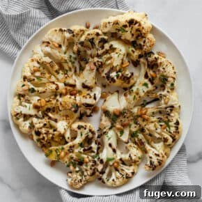 Grilled cauliflower steaks on a plate.