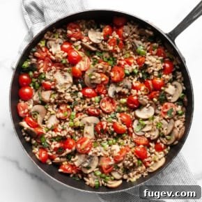 Mushroom tomato farro in a skillet.