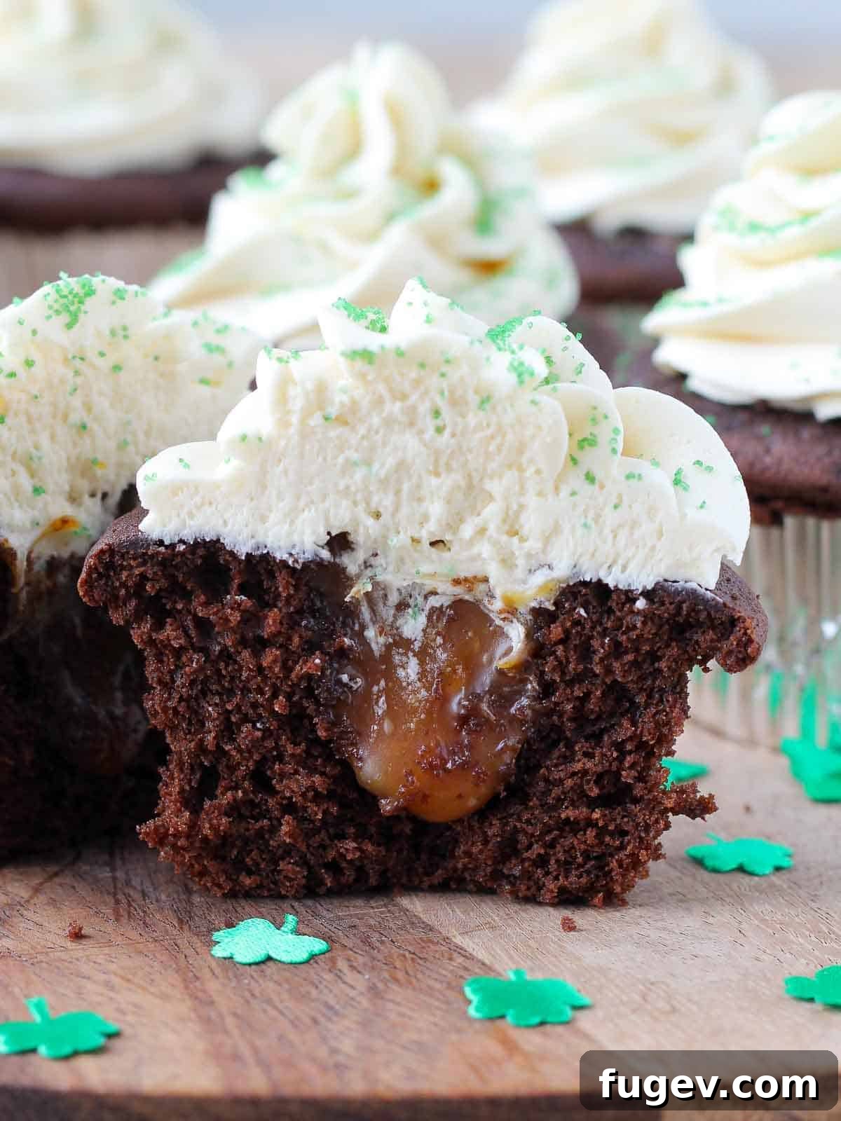 Luck of the Irish Cupcakes 2 A St. Patrick's Day cupcake sliced open to reveal a luscious salted caramel filling, showcasing the moist Guinness chocolate cake and creamy Baileys buttercream.