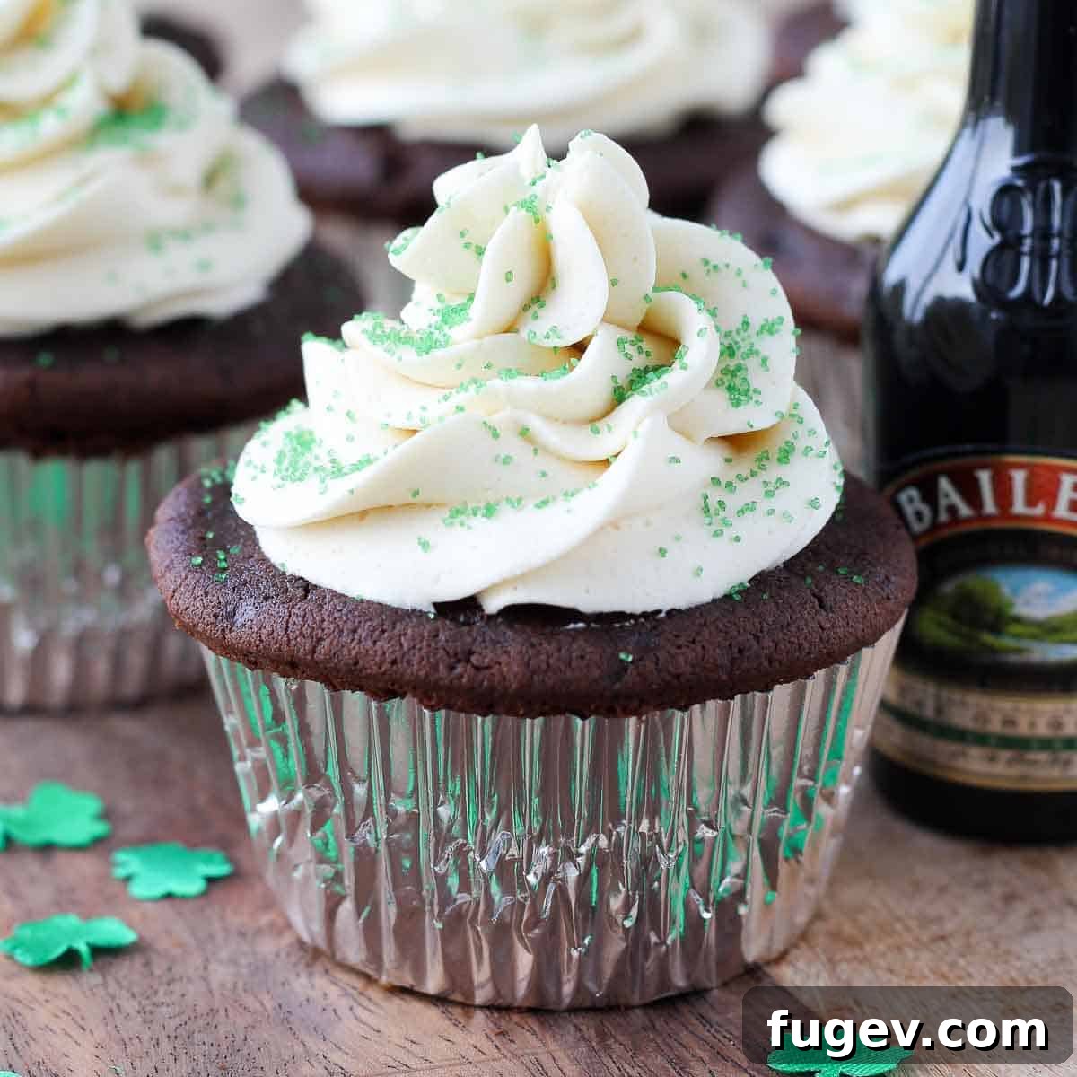 Luck of the Irish Cupcakes 3 Three perfectly frosted St. Patrick's Day cupcakes arranged artfully in front of a bottle of Baileys Irish Cream, hinting at the key ingredient.