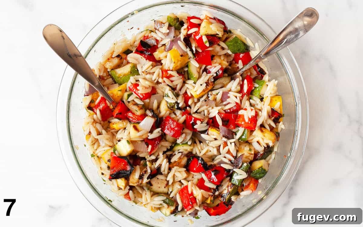 Smoky Garden Orzo Salad 7 A large bowl filled with a perfectly mixed grilled vegetable orzo pasta salad, showing the vibrant colors and textures.
