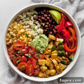 Assembled vegetarian burrito bowl with grilled veggies, black beans and pico de gallo.