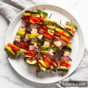 Grilled halloumi veggie skewers on a plate.