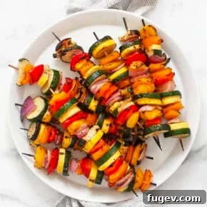Balsamic grilled vegetable skewers on a plate.