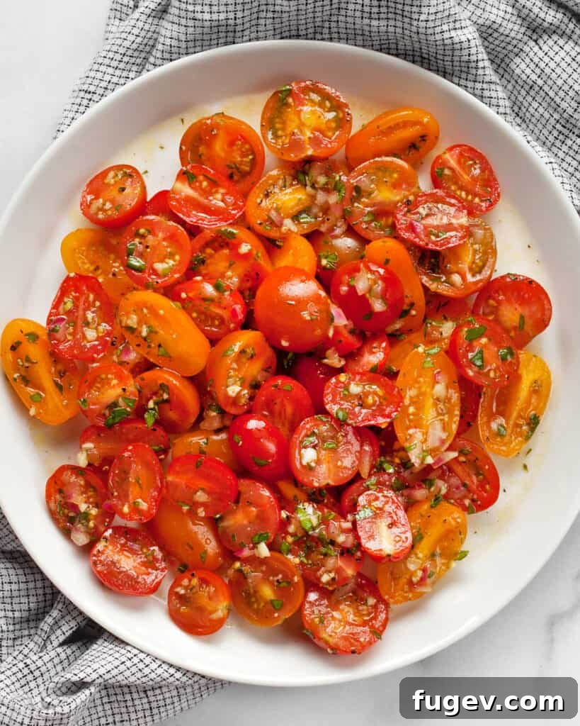 Zesty Marinated Cherry Tomatoes 5 A close-up of Marinated Cherry Tomatoes ready to be served, highlighting the fresh herbs and colorful tomatoes.