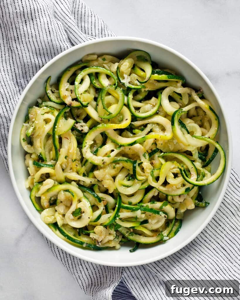 Fresh Zucchini Cacio e Pepe 3 Close-up of Zucchini Noodle Cacio e Pepe with visible black pepper and melted cheese.