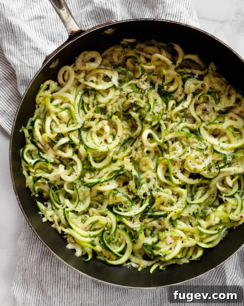 Fresh Zucchini Cacio e Pepe 5 Zucchini noodles sautéing in a hot skillet with garlic and olive oil.
