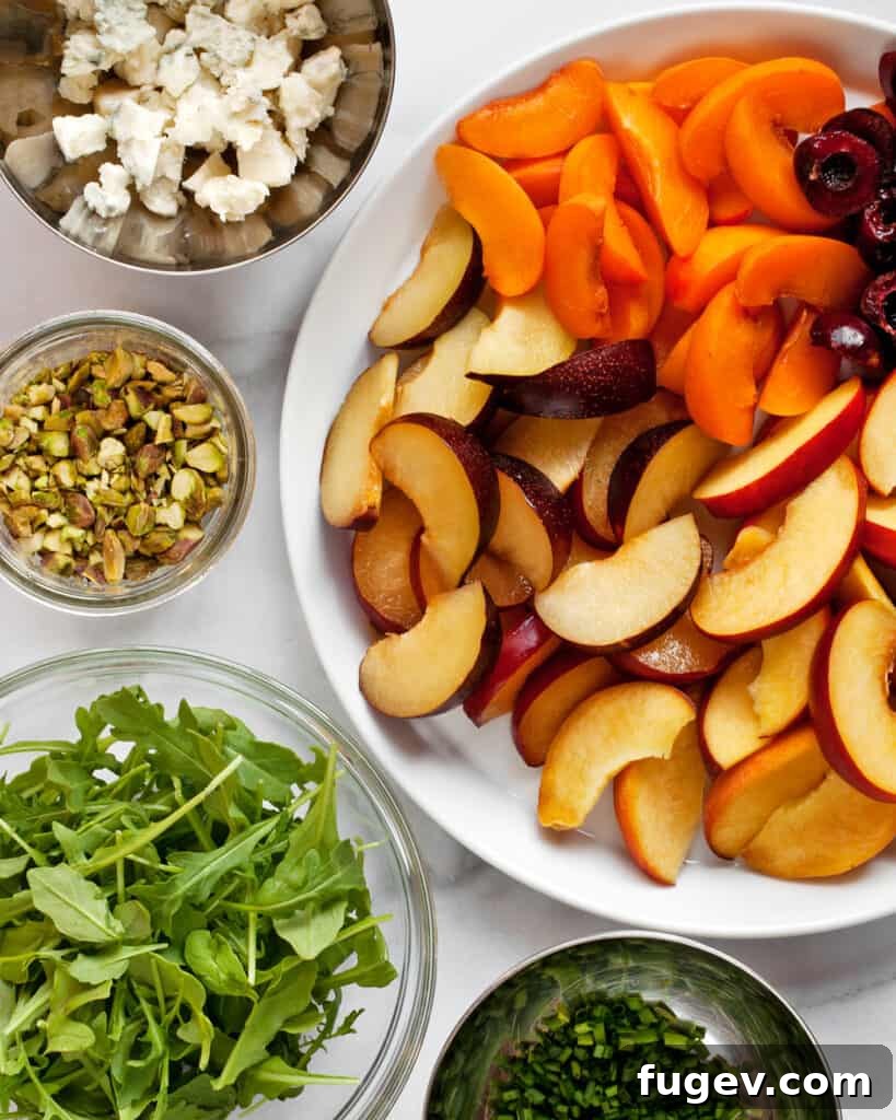 Summer Stone Fruit Salad with Creamy Gorgonzola and Zesty Pesto Vinaigrette 4 Assorted ingredients laid out on a board, ready for stone fruit salad preparation