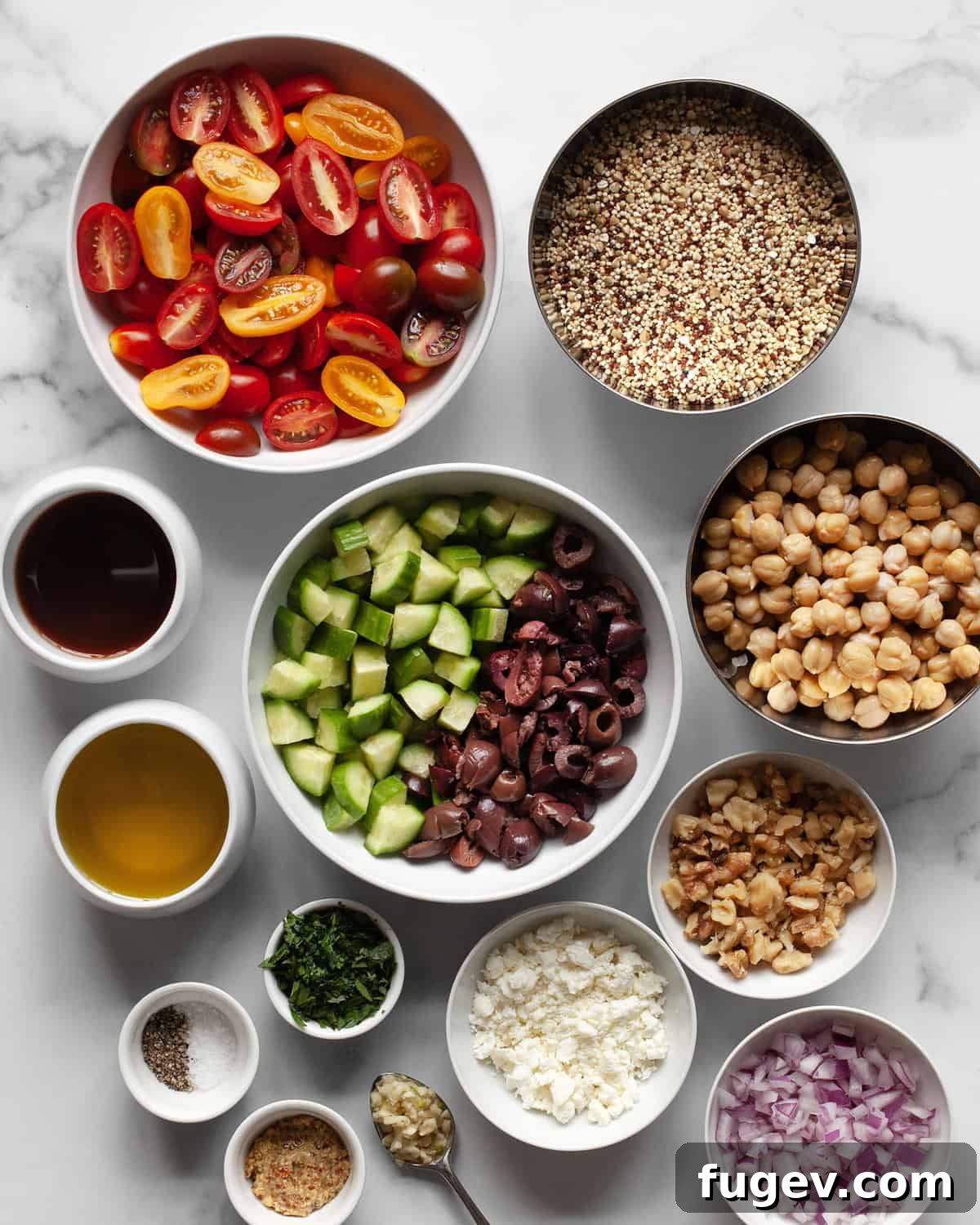 Roasted Tomato Quinoa and Chickpea Medley 3 Various fresh ingredients for the salad, including quinoa, chickpeas, cherry tomatoes, cucumbers, Kalamata olives, red onions, olive oil, and red wine vinegar.