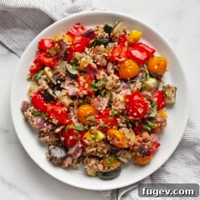A colorful and generous serving of Roasted Ratatouille Quinoa, brimming with oven-roasted vegetables.