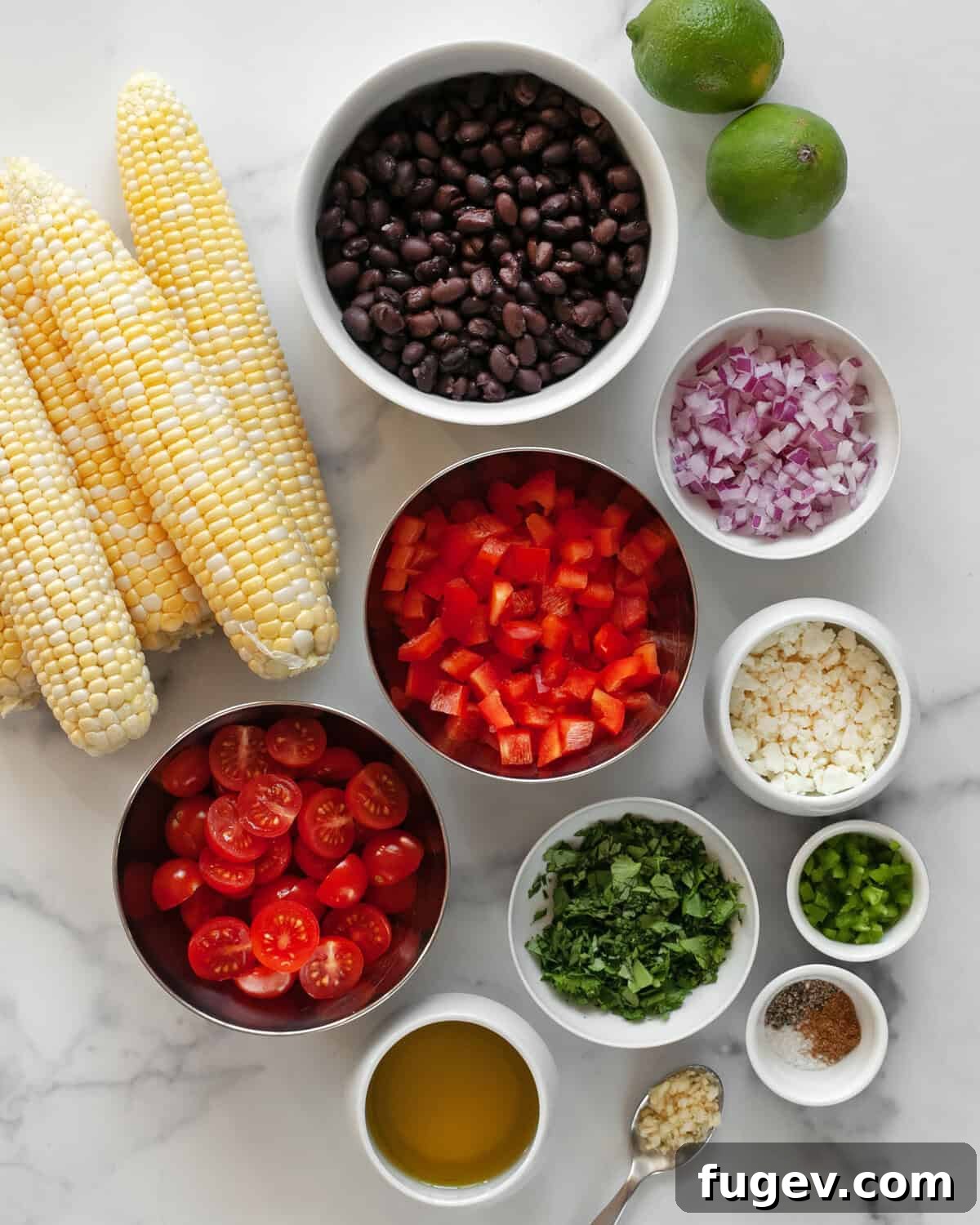 Southwestern Black Bean and Corn Medley 3 Ingredients for black bean and corn salad laid out on a wooden surface, including black beans, corn cobs, red peppers, red onions, cilantro, jalapeños, garlic, limes, and olive oil.