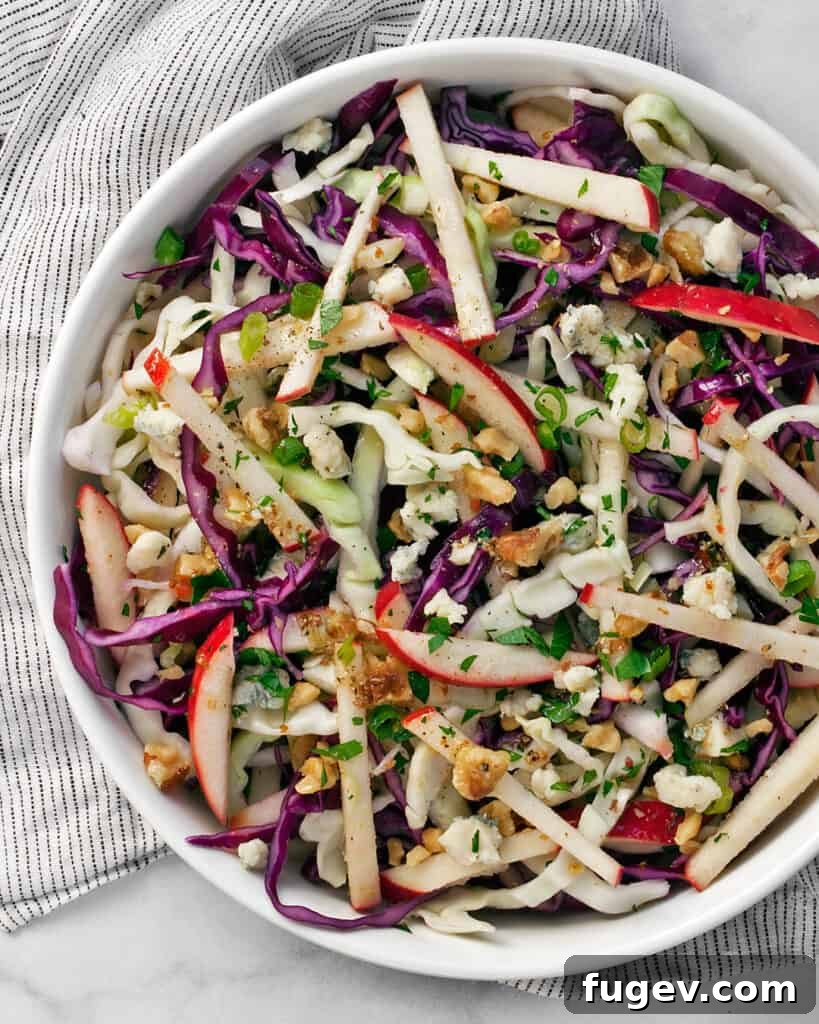 Apple Cabbage Salad with Champagne Vinaigrette Colorful Apple Cabbage Salad featuring green and red cabbage, apples, walnuts, and blue cheese.