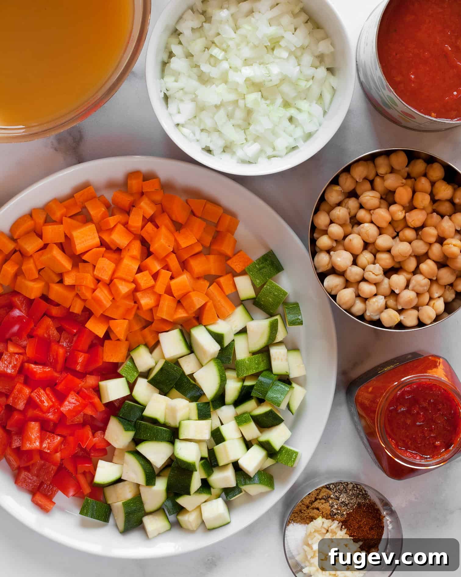 Harissalı Nohutlu Sebze Çorbası 3 Fresh ingredients laid out for Chickpea Harissa Vegetable Soup: carrots, red peppers, zucchini, harissa, canned tomatoes, and spices.