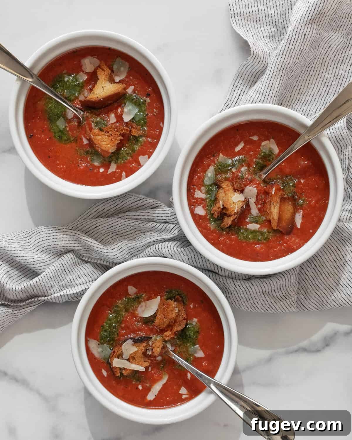 Pantry-Powered Roasted Tomato Soup 7 Three beautifully presented bowls of roasted tomato soup, ready to be enjoyed.