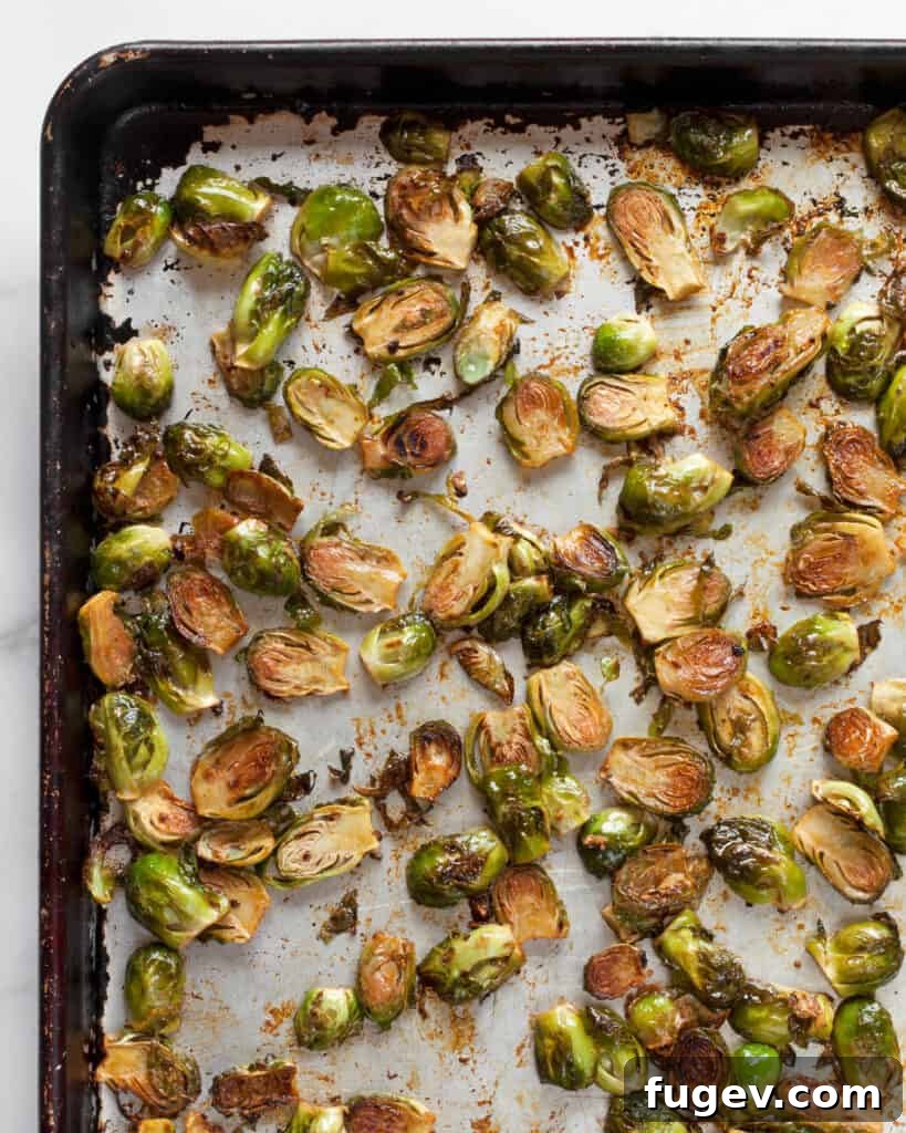 Sticky Sweet Heat Brussels Sprouts 7 Roasted brussels sprouts on a sheet pan, golden brown and crispy
